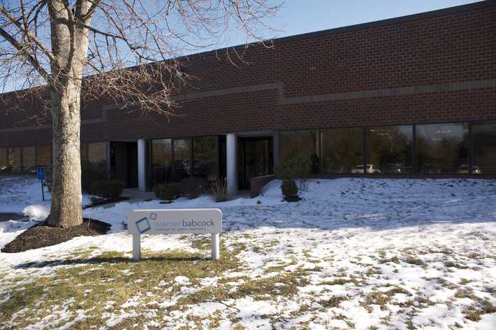 an image of the warner babcock institute from the outside. it is a two story brick building. there is snow on the ground.