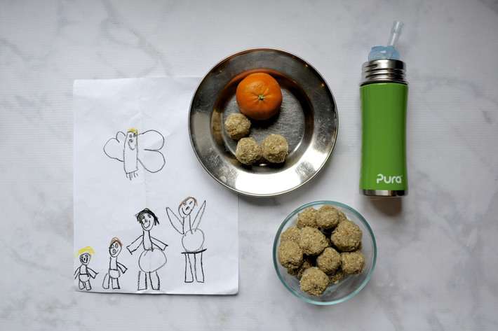 nut-free snack bites on a plate with kids artwork and a water bottle