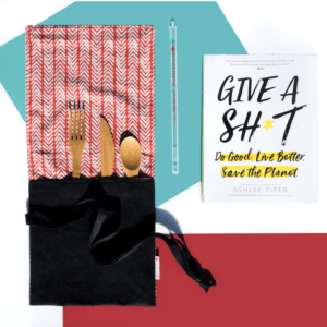 picture of a reusable straw and utensil set in a carry pouch and a book called Give A Shit about how to live eco-friendly