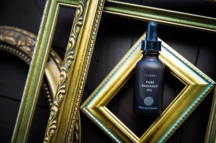 true botanicals products lined up and styled with gold frames