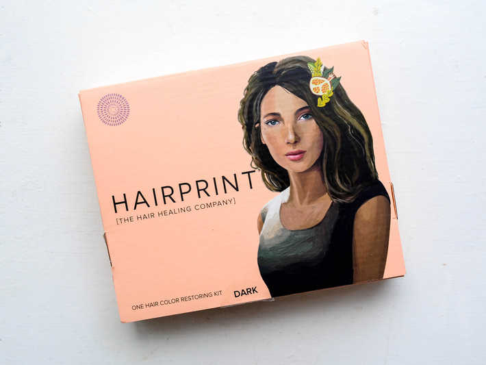 A pink Hairprint box sits on a white table.