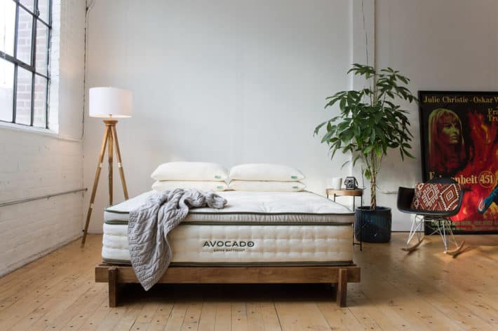 a mattress from avocado sits in a bedroom