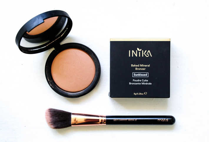 Inika bronzer open and styled on a white background