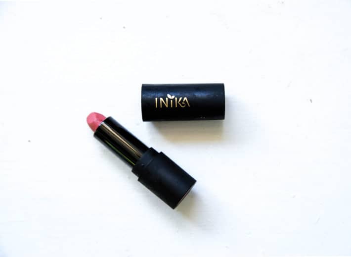 Inika lipstick styled on a white background