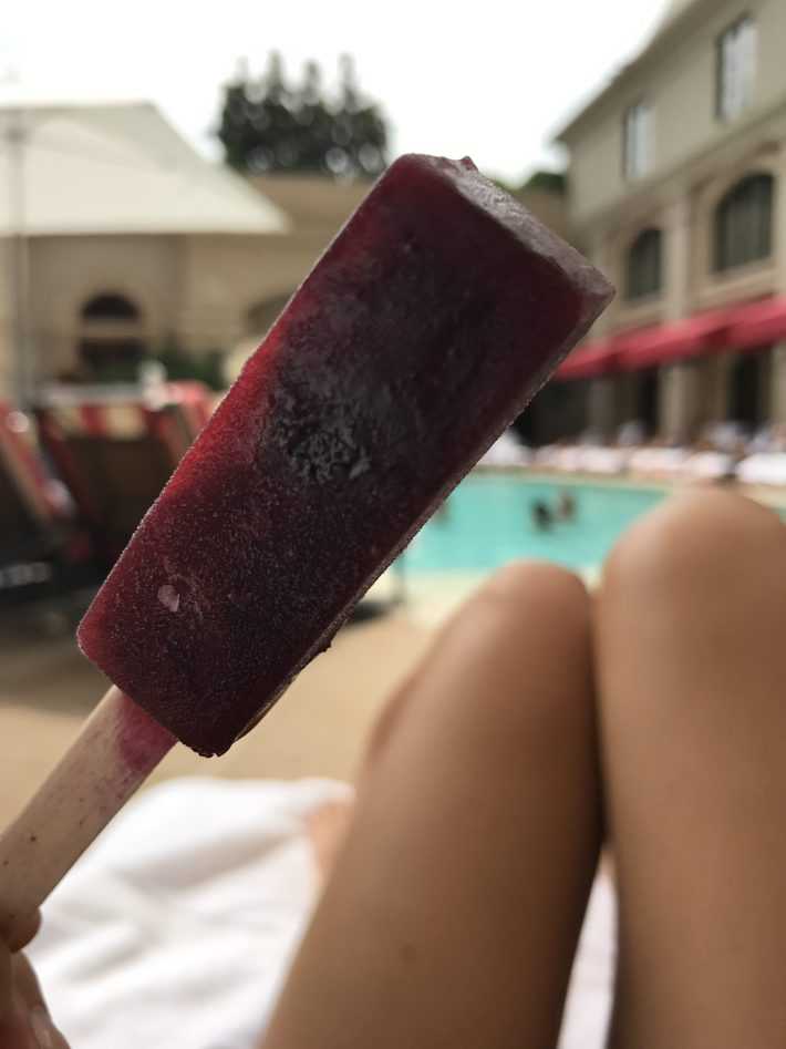 the st regis pool staff in atlanta hands out popsicles to keep guests cool on hot days this one is square and long and purple 