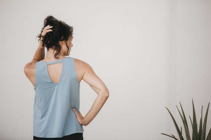 wearing a blue tank top with a cut out in the back 