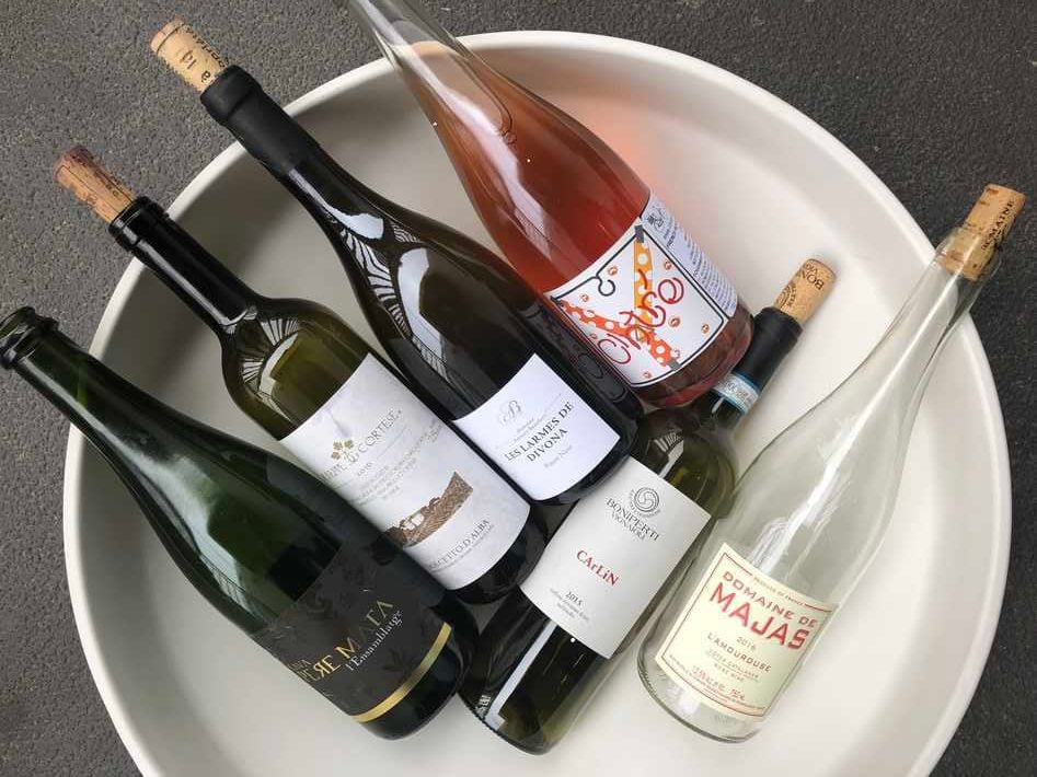 6 bottles of wine resting in a white tub