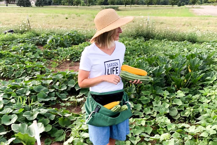 wearing the roo apron while picking veggies in the garden 