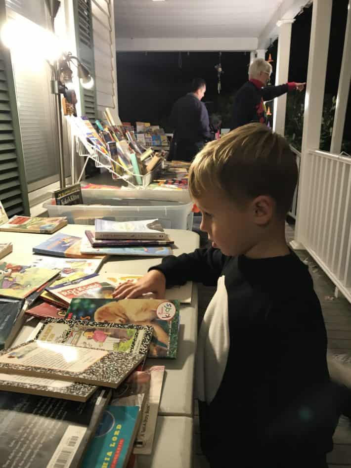 My 4-year-old shopping books on Halloween at a neighbors