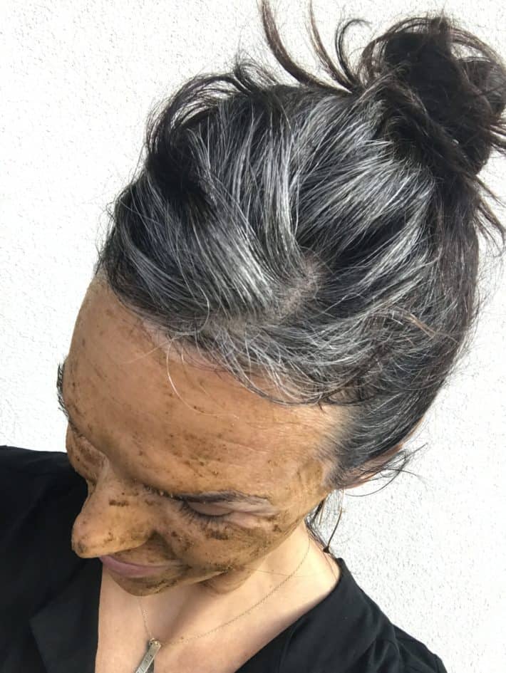 Photo of a woman who
is growing her hair out to be gray. This photo shows what the hair color looks like 4
months into the graying process