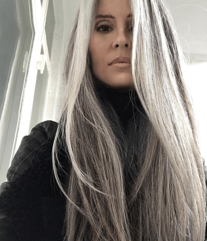 A woman with long graying hair.