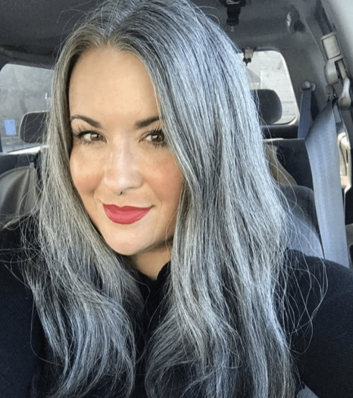 A woman with wavy gray hair.