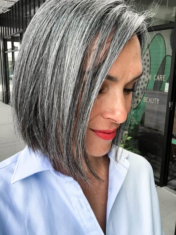 Photo of a woman who
is growing her hair out to be gray. This photo shows what the hair color looks like 2 years into the graying process