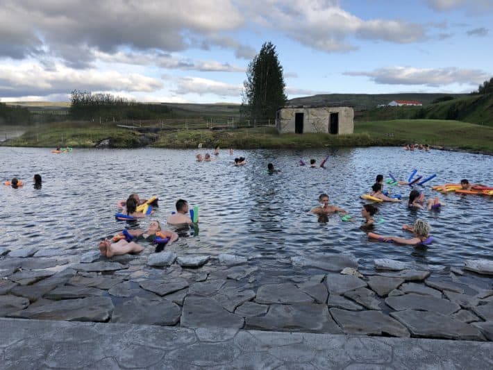 a bunch of people on noodles in a natural pool Iceland