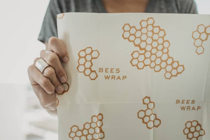holding Bee's Wrap up to show honeycomb pattern and size
