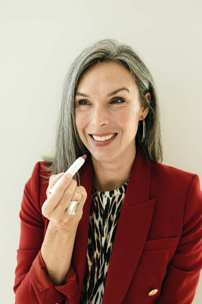 Lisa applies a French nude tinted lip oil.