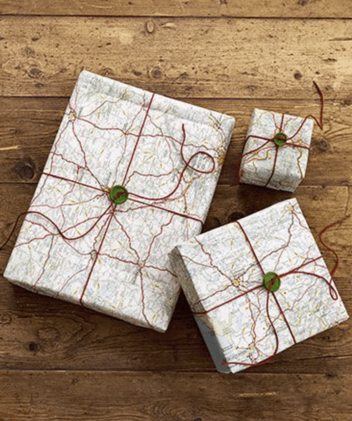three gifts wrapped in old maps