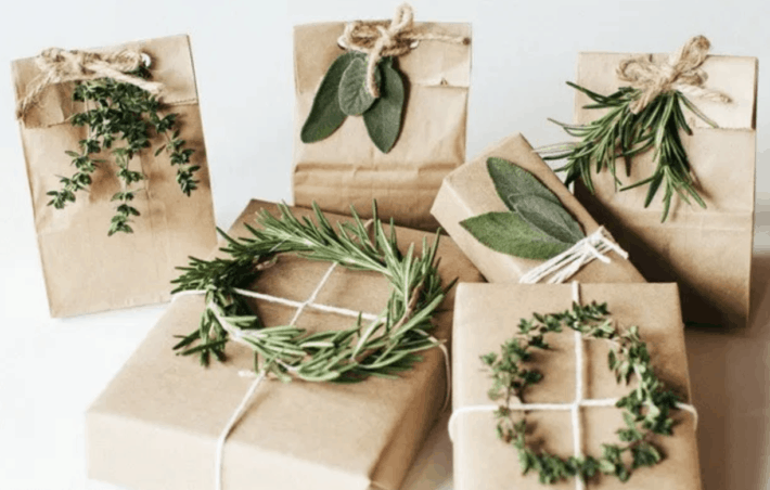 brown paper wrapped gifts with fresh greenery