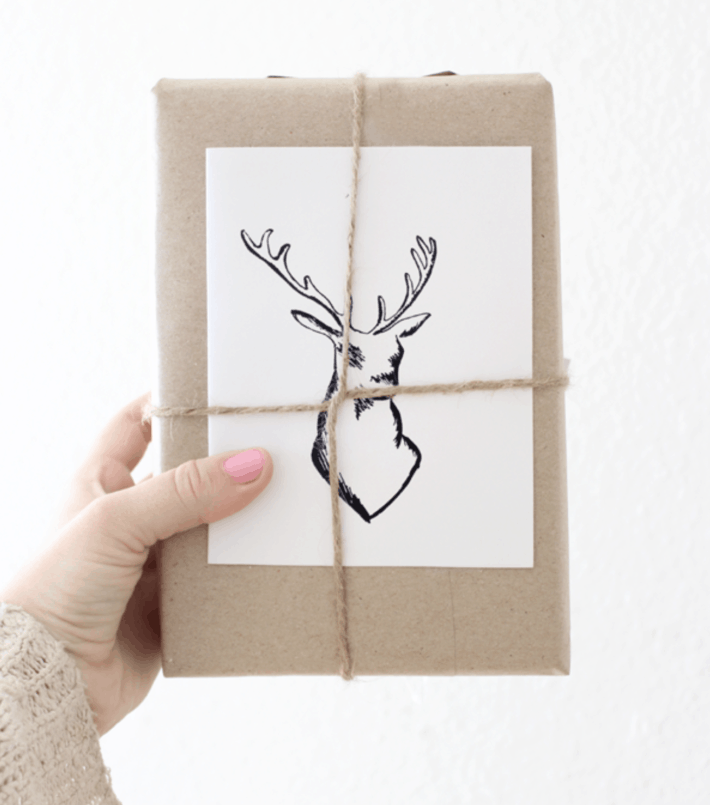 sketch of an elk or deer centered on a brown paper wrapped gift
