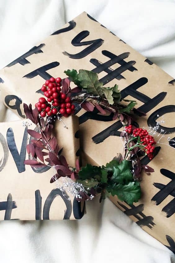 painted hashtags on brown paper with berries and greenery to finish