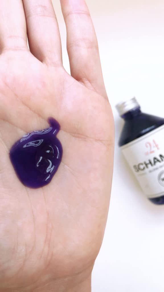 A sample of Bruns SCHAMPO N24 purple shampoo in the palm of a hand