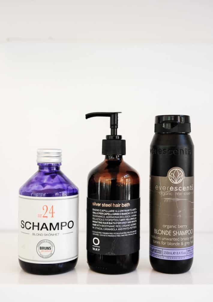 3 bottles of purple shampoo with labels and logos showing