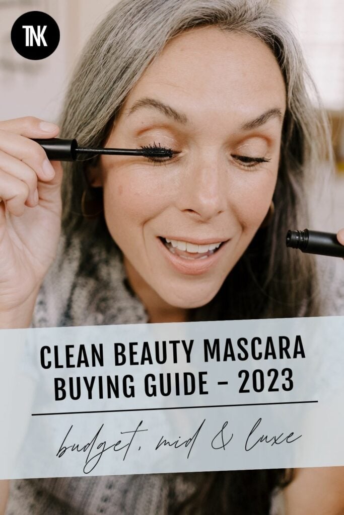 A woman applies mascara
