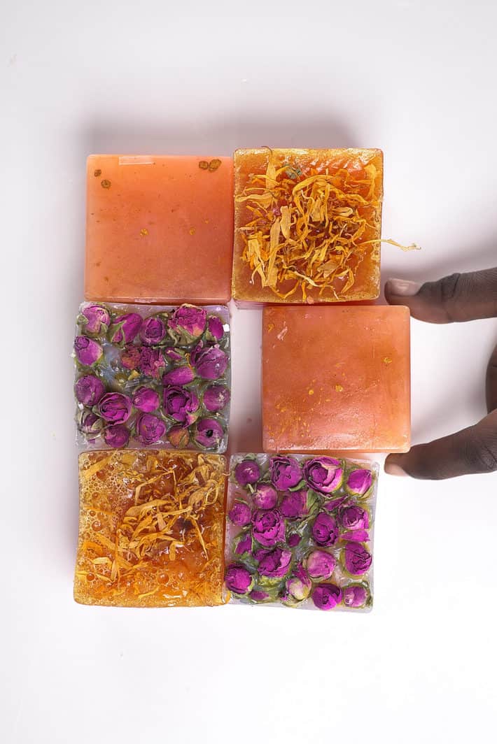 six samples of IYOBA handmade soaps laid out on white surface