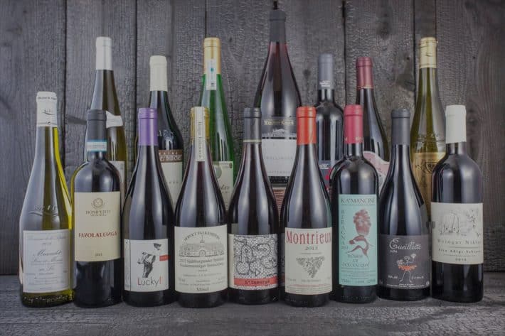 a bunch of natural wine bottles lined up