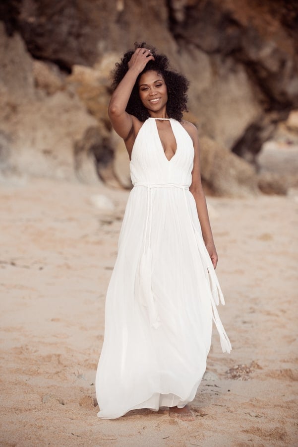 portrait of Dana Jackson wearing white floor length dress standing on a beach