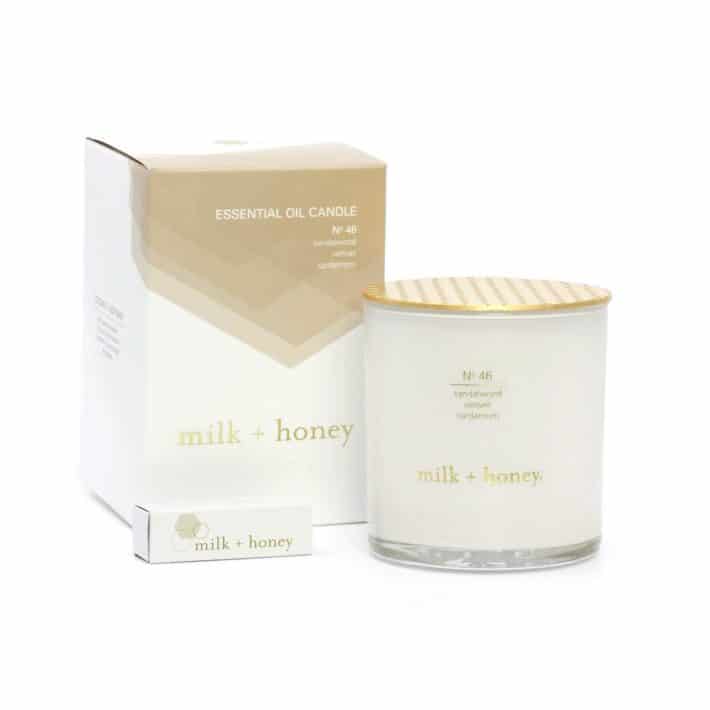Milk + Honey candle placed next to its packaging