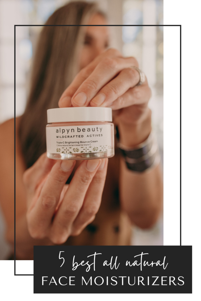 a woman holds up a tub of alpyn beauty moisturizer