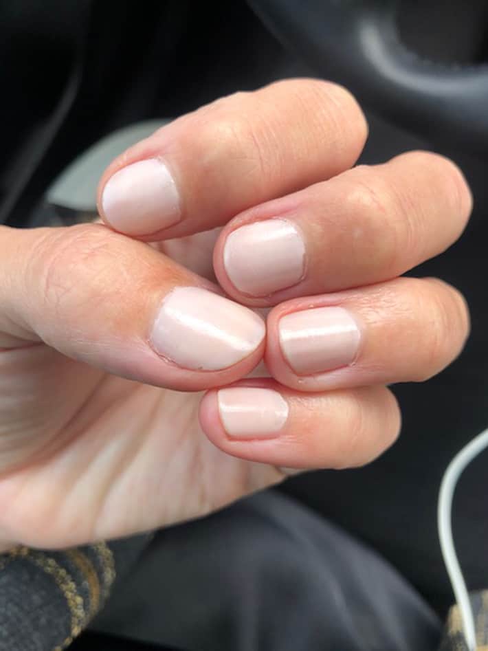 Lisa's hand showing day 3 of Cote nail polish No. 7, a neutral almond shade.