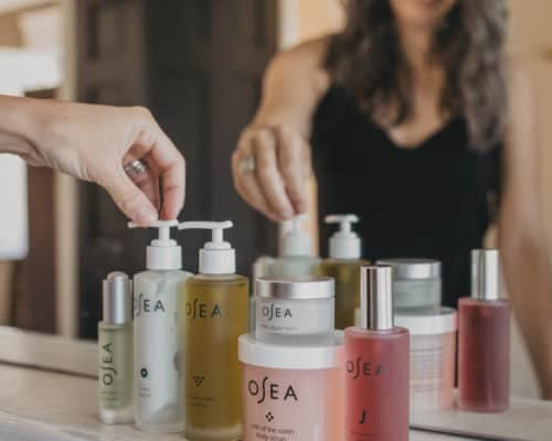 all of the OSEA lined up at the sink, reaching for the ocean cleanser