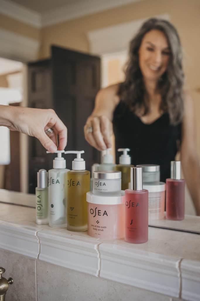all of the OSEA lined up at the sink, reaching for the ocean cleanser