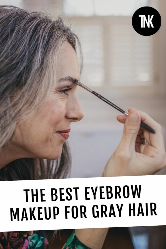 a woman applies eyebrow makeup to her brows.