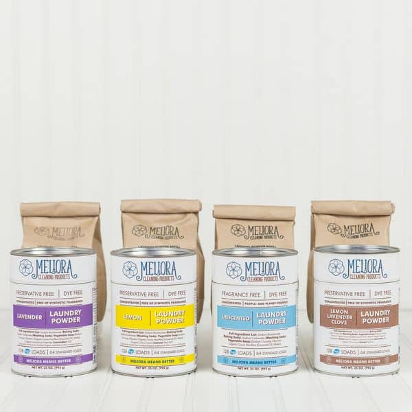 four scents of meliora laundry detergent, powdered, lined up on a counter