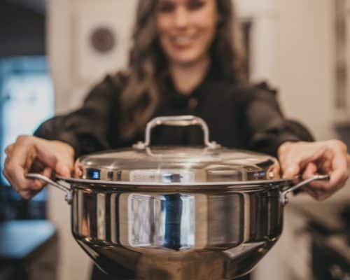 woman holding pot in hands from 360 cookware