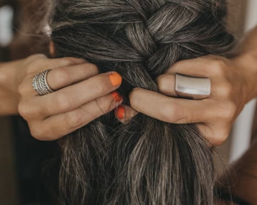 Lisa braids her gray hair into an original French braid.