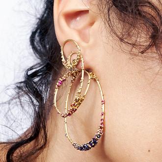 A woman with hoop earrings in her ear