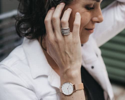 woman wearing ring and watch from sustainable jewelry brands