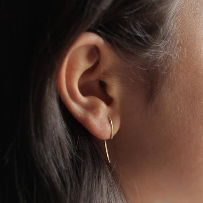 woman wearing sustainable minimal earrings 