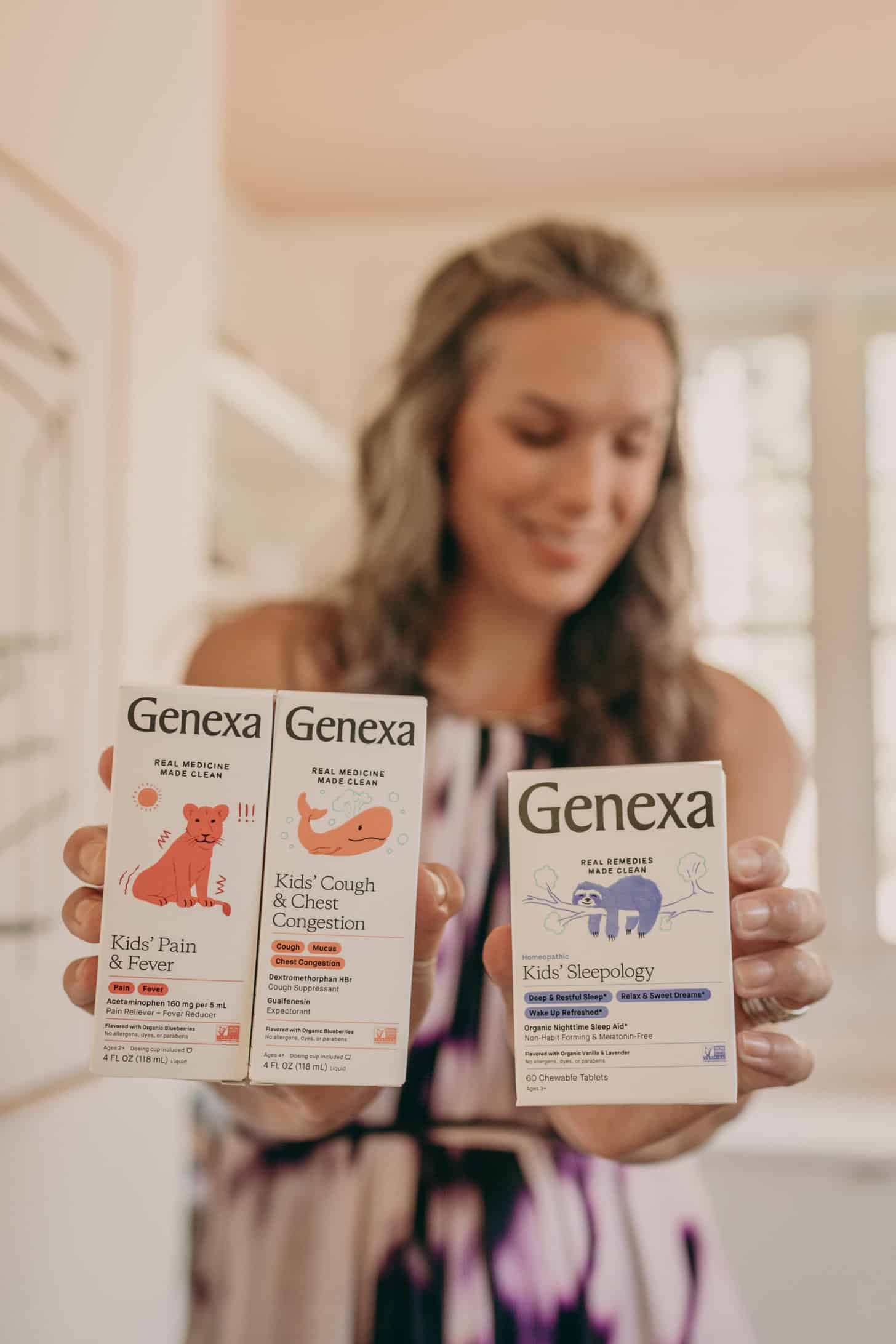 Lisa holds three Genexa clean medicine options for the audience to see.