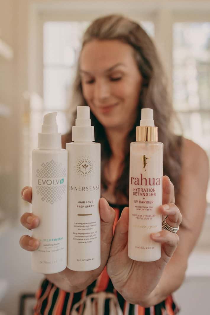 Lisa holds out three of her favorite better beauty haircare products.