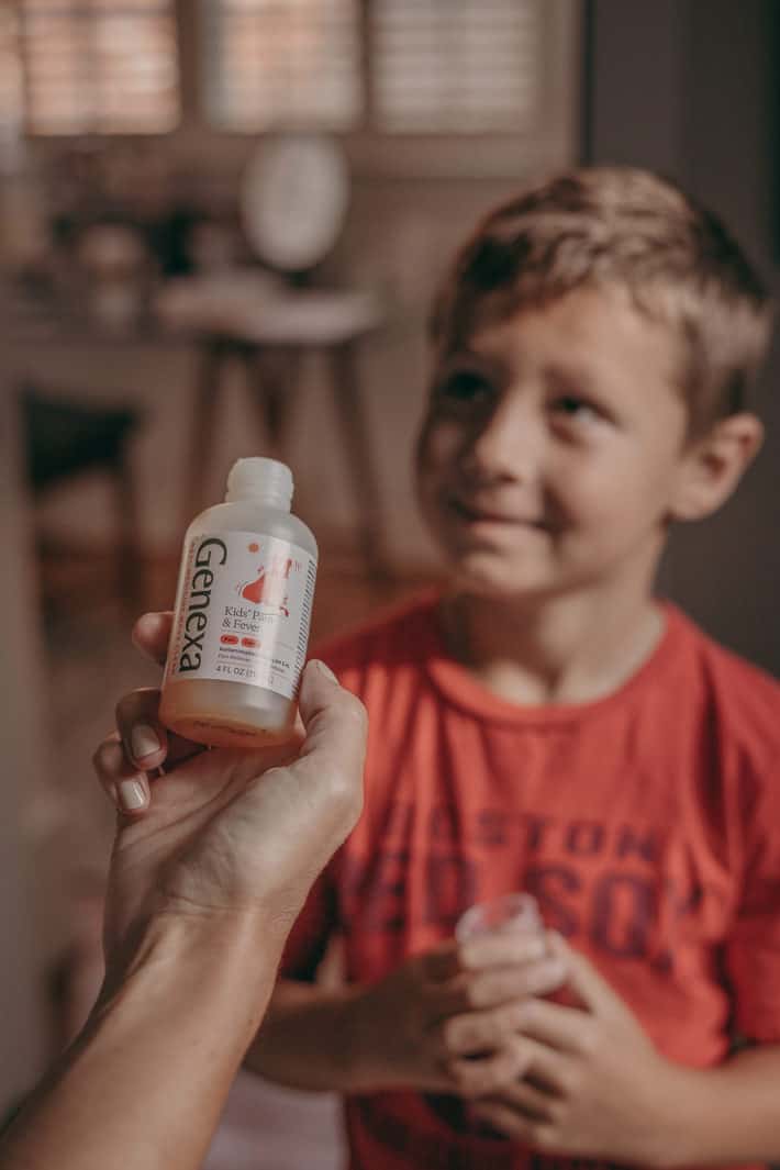 A little boy with a bottle of medicine