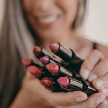 woman holding lipsticks