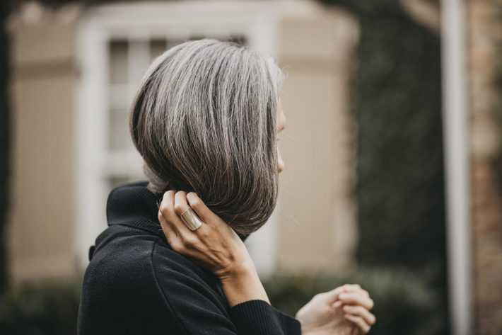 woman holding gray hair 