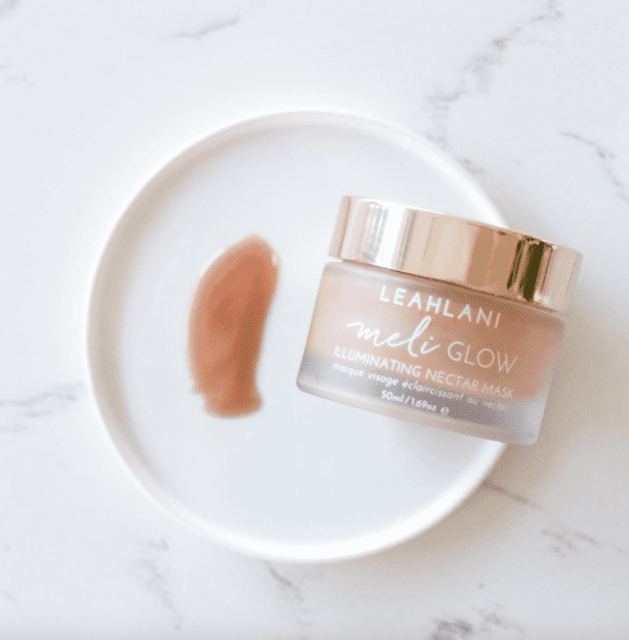 leahlani's meli glow is a blush colored honey based mask - swatched on a plate next to the jar