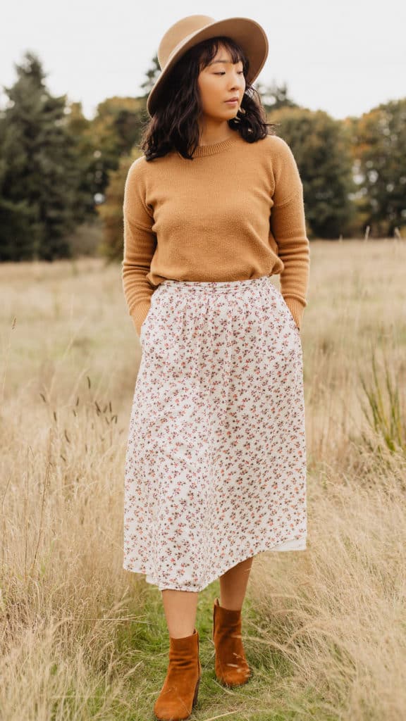 wearing a floral midi skirt in a field 