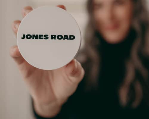 woman holding jones road product in her hand
